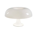 Lampe de chevet forme champignon blanche posée sur une table de nuit